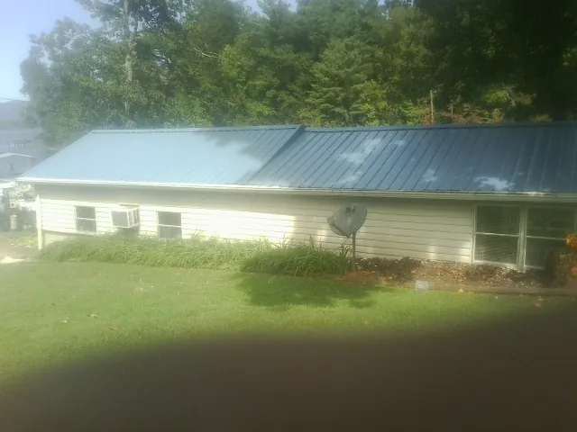Blue metal roof running the length of a single story home in Ardenvoir