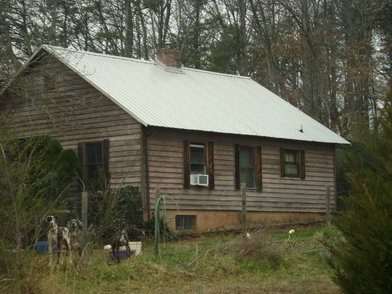 White metal roof on an old wood sided farmhouse, from a Metal Roof Installation job in Ardenvoir